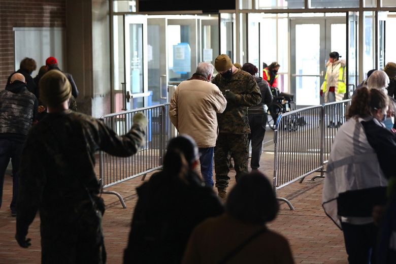 Soldiers check IDs of people as they arrive on the first day of the FEMA COVID-19 vaccination site at the Pennsylvania Convention Center in Center City Philadelphia on Wednesday, March 3, 2021. The omicron surge has caused 9,000 deaths in Pennsylvania since Dec. 1, 2021. (Tim Tai / The Philadelphia Inquirer / TNS) Soldiers check IDs of people as they arrive on the first day of the FEMA COVID-19 vaccination site at the Pennsylvania Convention Center in Center City Philadelphia on Wednesday, March 3, 2021. The omicron surge has caused 9,000 deaths in Pennsylvania since Dec. 1, 2021. (Tim Tai / The Philadelphia Inquirer / TNS)