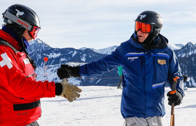 Stevens Pass Ski Resort – Tom Fortune new GM and opening of the backside – 012822
New interim General Manager Tom Fortune shakes hands with ski patroller Richard Walther on the top of the backside Friday, Jan. 28, 2022 at Stevens Pass, Wash. The backside opened for the first time that day. 219454