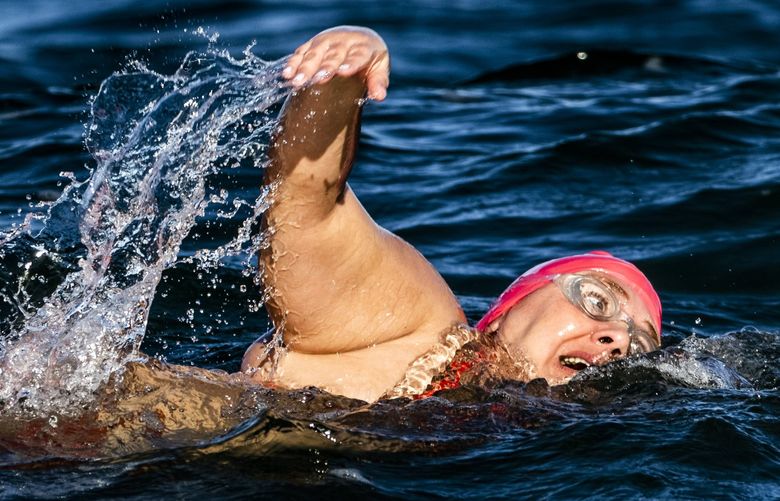 Melissa Kegler takes on the February waters as she swims at Alki Beach in West Seattle on Saturday, Feb. 12, 2022.