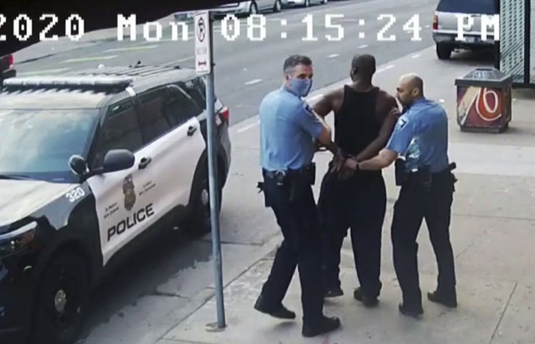 FILE – This image from video shows Minneapolis Police Officers Thomas Lane, left and J. Alexander Kueng, right, escorting George Floyd, center, to a police vehicle outside Cup Foods in Minneapolis, on May 25, 2020. The two and another former Minneapolis officers are on trial in February 2022, on federal civil rights charges in Floyd’s death. All three are expected to testify. Kueng took the stand Wed. Feb. 16, 2022 in the trial. (Court TV via AP, Pool, File) CER502 CER502