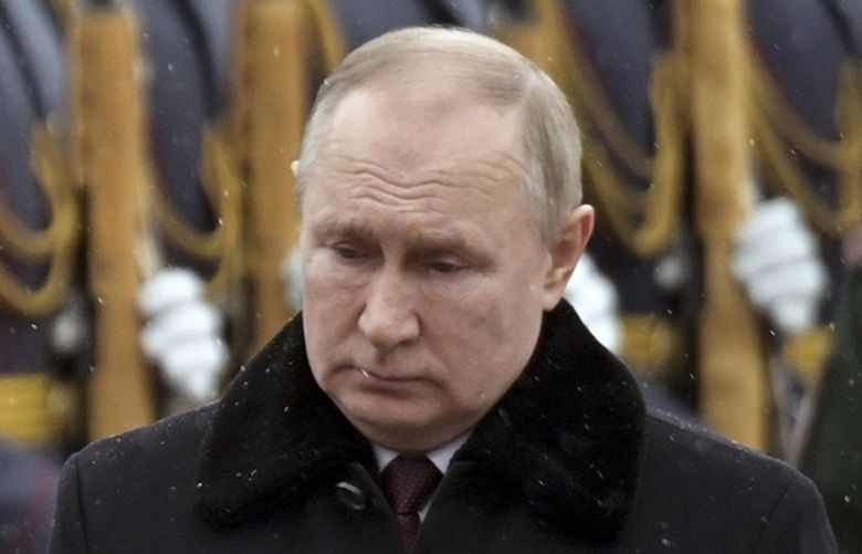 Russian President Vladimir Putin attends a wreath-laying ceremony at the Tomb of the Unknown Soldier, near the Kremlin Wall during the national celebrations of the ‘Defender of the Fatherland Day’ in Moscow, Russia, Wednesday, Feb. 23, 2022. The Defenders of the Fatherland Day, celebrated in Russia on Feb. 23, honors the nation’s military and is a nationwide holiday. (Alexei Nikolsky, Kremlin Pool Photo via AP) XAZ107 XAZ107