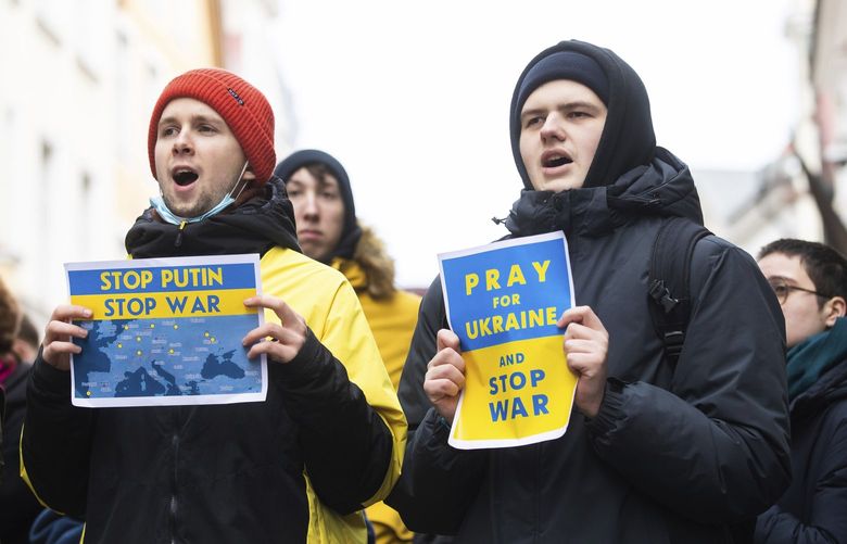 People including Ukrainians, take part in a demonstration in support of Ukraine, outside the Russian Embassy in Tallinn, Estonia, Thursday, Feb. 24, 2022. Russia launched a wide-ranging attack on Ukraine on Thursday, hitting cities and bases with airstrikes or shelling, as civilians piled into trains and cars to flee. Ukraine’s government said Russian tanks and troops rolled across the border in a “full-scale war” that could rewrite the geopolitical order and whose fallout already reverberated around the world. (AP Photo/Raul Mee) XAZ144 XAZ144