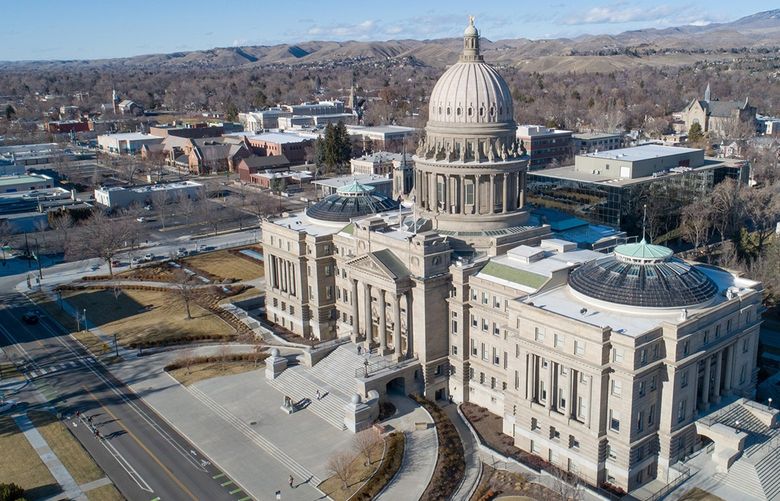 The law in focus forbids ‘a body of men,’ other than the National Guard, to ‘associate themselves together as a military company or organization, or parade in public with firearms in any city or town of this state.’ An aerial view of the Idaho State Capitol building in Boise. (Dreamstime/TNS) 40984003W 40984003W