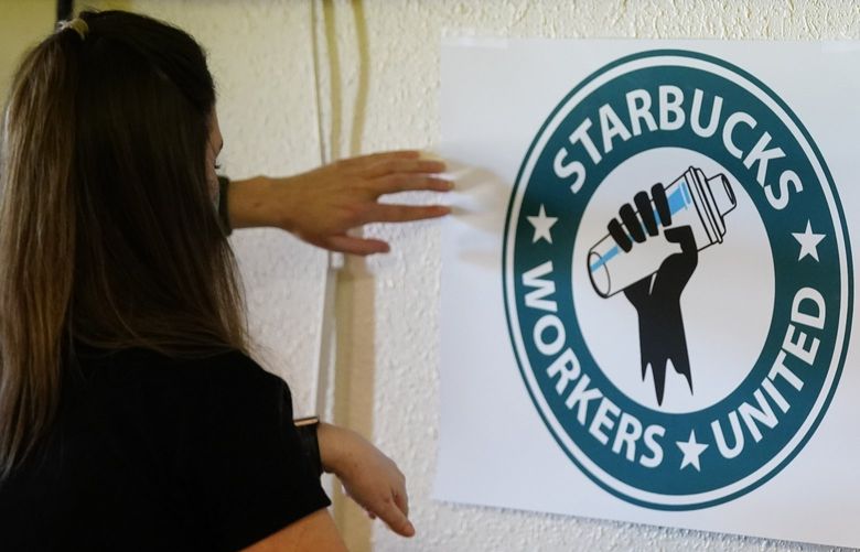 FILE – Michelle Eisen, a barista at the Buffalo, N.Y., Elmwood Starbucks location, helps out the local Starbucks Workers United, employees of a local Starbucks, as they gather at a local union hall to cast votes to unionize or not, on Feb. 16, 2022, in Mesa, Ariz. With an appeal request by Starbucks rejected. workers at one of the coffee giant’s Mesa, Arizona, locations will vote Friday, Feb. 25, 2022, on whether or not to unionize. If the union wins out, it would be one of the first aside from two stores in Buffalo, New York, to organize. (AP Photo/Ross D. Franklin, File) FX503 FX503