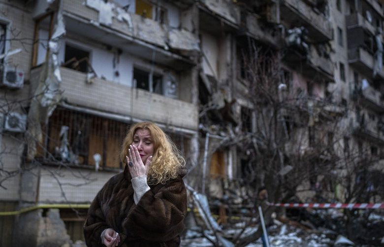 Natali Sevriukova reacts next to her house following a rocket attack the city of Kyiv, Ukraine, Friday, Feb. 25, 2022. (AP Photo/Emilio Morenatti) EM101 EM101