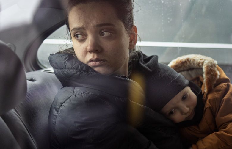 Olha Zapotochna and her three-year-old son Arthur enter Poland after crossing the border from Ukraine in Medyka, Poland, Feb. 25, 2022. She was headed to stay with her in-laws in Poland. (Maciek Nabrdalik/The New York Times) XNYT25 XNYT25