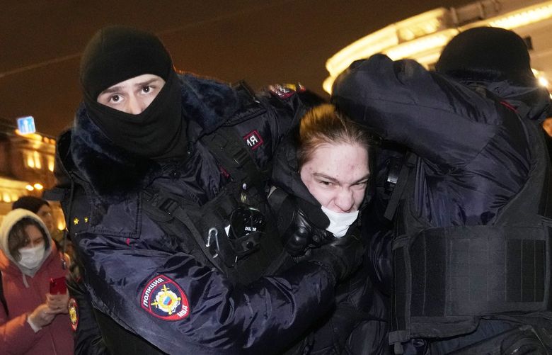 Police officers detain a demonstrator in St. Petersburg, Russia, Thursday, Feb. 24, 2022. Hundreds of people gathered in the centers of Moscow and St.Petersburg on Thursday, protesting against Russia’s attack on Ukraine. (AP Photo/Dmitri Lovetsky) 