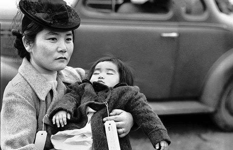 This photograph of Fumiko Hayashida and her 1-year-old daughter Natalie, taken March 30, 1942, became a symbol of the forced evacuation of Japanese residents from Bainbridge Island. While the image became iconic, Hayashida’s identity remained a mystery for decades. Credit: Unknown Photographer / Courtesy Museum of History & Industry