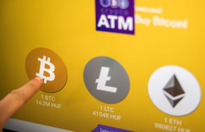 Bitcoin, left, Litecoin, center, and Ethereum logos on the screen of a cryptocurrency automated teller machine (ATM) in Budapest, Hungary, on Friday, Feb. 18, 2022. . Photographer: Akos Stiller/Bloomberg