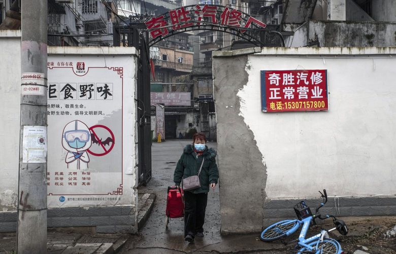 FILE – A poster advising against the consumption of wild animals in Wuhan, China, on Jan. 22, 2021. A pair of extensive studies released on Feb. 25, 2022 point to the Huanan Seafood Wholesale Market here as the origin of the coronavirus pandemic. (Gilles Sabrie/The New York Times)