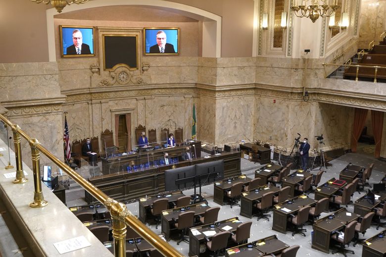 House Republican Leader J.T. Wilcox, R-Yelm, is displayed on video screens as he speaks remotely during the opening session of the Washington state House, Jan. 10, 2022, at the Capitol in Olympia, Wash. 