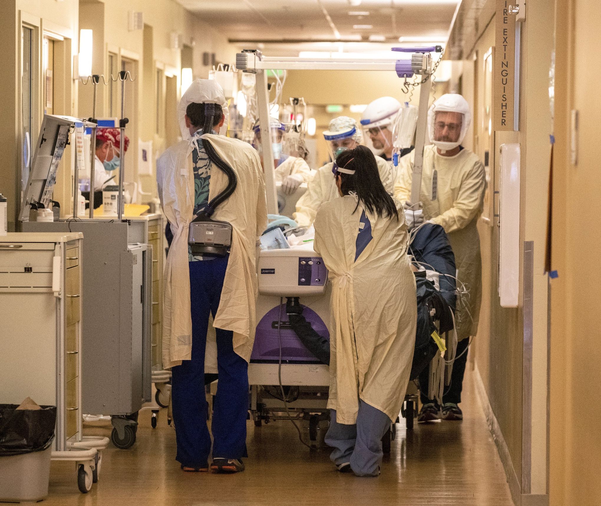 A medical team moves a COVID-19 patient to a new room