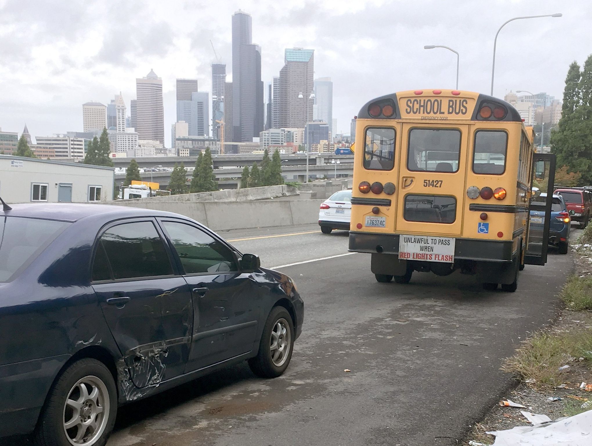 A bus and car pulled over on I-5 after a collision