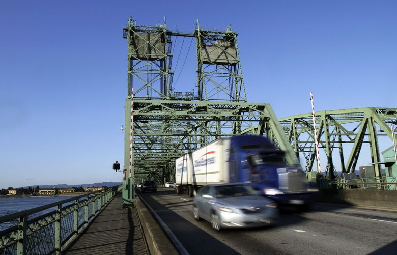 In this Thursday, Aug. 4, 2011, photo, early morning traffic crosses the Interstate 5 bridge between Oregon and Washington states in Vancouver, Wash. One of the casualties of the coming federal budget crunch could be a new $3-billion bridge to replace the current bridge.(AP Photo/Don Ryan)