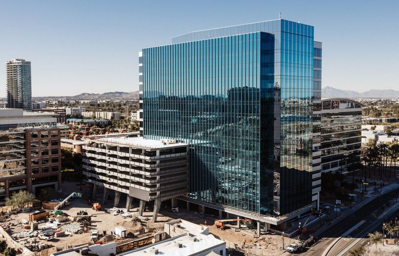 – EMBARGO: NO ELECTRONIC DISTRIBUTION, WEB POSTING OR STREET SALES BEFORE 3:01 A.M. ET ON TUESDAY, FEB. 22, 2022. NO EXCEPTIONS FOR ANY REASONS –  A 17-story office building in Tempe, Ariz., known as 100 Mill, under construction on Feb. 7, 2022. The development is expected to house about 550 Amazon employees when finished. (Adam Riding/The New York Times) XNYT148 XNYT148