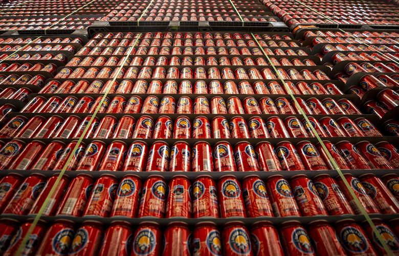 Prisms of canned beer ready for packing inside Denver Beer Company’s production facility in the city’s Sunnyside neighborhood. Tuesday, Feb. 8, 2022, in Denver. (Kevin J. Beaty/Colorado Public Radio via AP) DX103 DX103