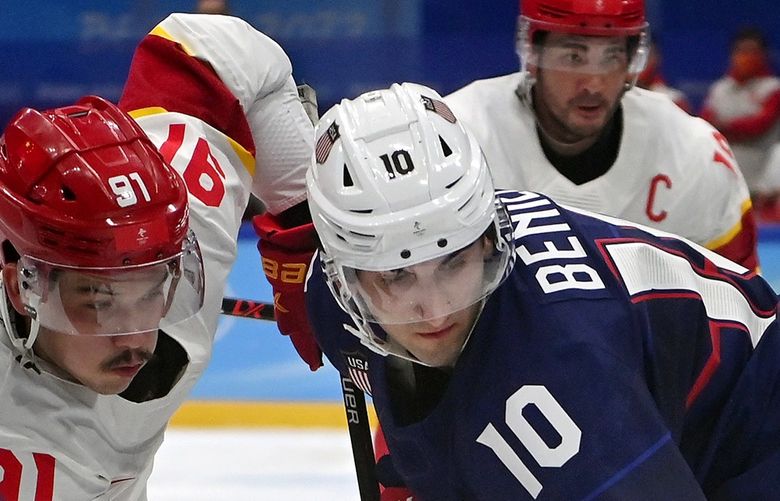 United States forward Matty Beniers (10) and China forward Taile Wang (91) go after the puck during their preliminary round hockey matchup at the 2022 Winter Olympics in Beijing on Thursday, Feb. 10, 2022. (James Hill/The New York Times)