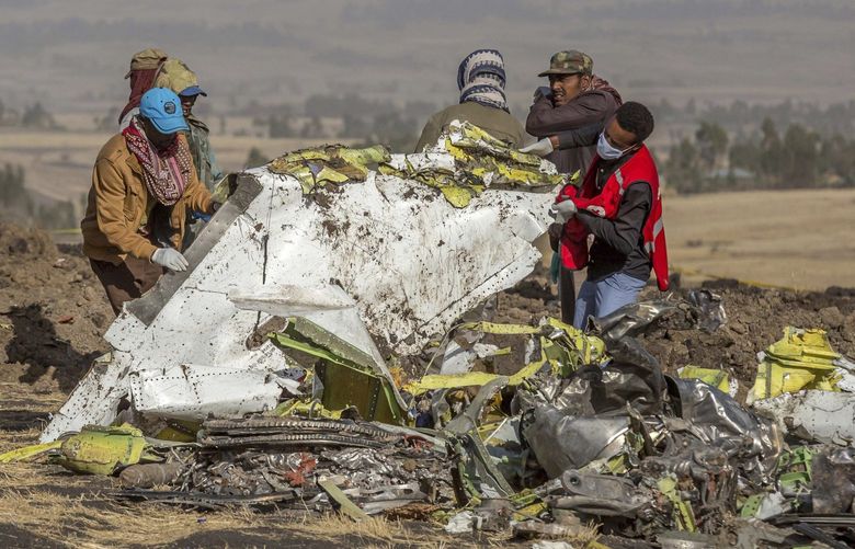 Rescuers work at the scene of an Ethiopian Airlines flight crash near Bishoftu, or Debre Zeit, south of Addis Ababa,  Ethiopia, Monday, March 11, 2019. A spokesman says Ethiopian Airlines has grounded all its Boeing 737 Max 8 aircraft as a safety precaution, following the crash of one of its planes in which 157 people were killed. (AP Photo/Mulugeta Ayene)