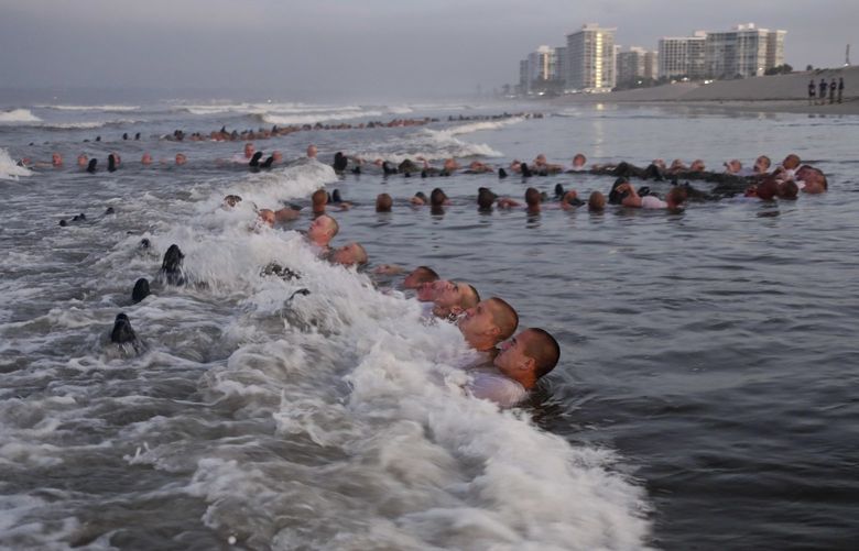 In a photo from the U.S. Navy, Navy SEAL candidates take part in “surf immersion” during basic underwater demolition training in Coronado, Calif., May 4, 2020. One Navy SEAL candidate died and another was hospitalized after completing several days of excruciating training known as “Hell Week” in Coronado, Calif., Navy officials said on Saturday, Feb. 5, 2022. (Anthony Walker/U.S. Navy via The New York Times) — FOR EDITORIAL USE ONLY XNYT47 XNYT47