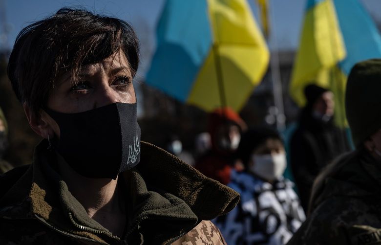 A member of the Ukrainian military cries during a ceremony in Severodonetsk, in Eastern Ukraine, on Feb. 20, 2022, honoring the protesters known as the “Heavenly Hundred,” who were killed by security forces in Kyiv in February 2014. Eight years after protesters were gunned down in Kyiv, Ukraine faces even greater peril.(Lynsey Addario for The New York Times) -NO SALES-