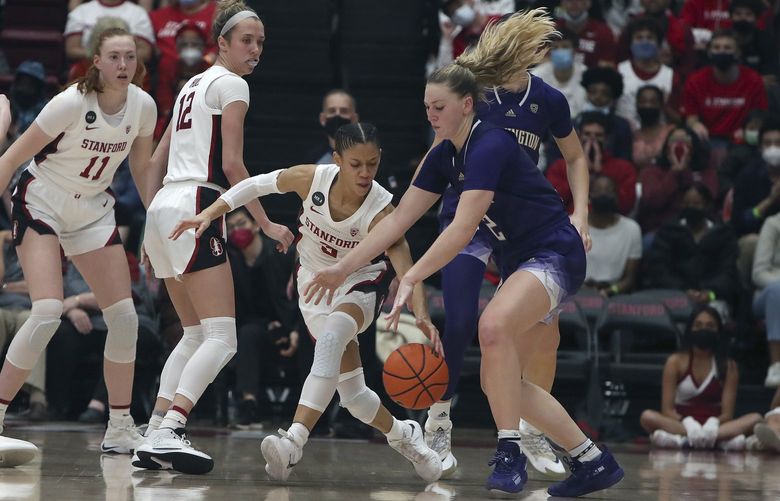 Stanford guard Anna Wilson (3) picks the ball from Washington forward Lauren Schwartz (2) in the second half of an NCAA college basketball game Saturday, Feb. 26, 2022, in Stanford, Calif. (AP Photo/Scot Tucker) CAST118 CAST118