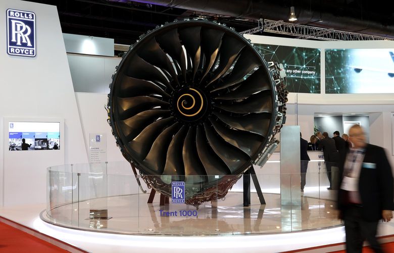An attendee walks past a Rolls-Royce Holdings Plc Trent 1000 aircraft engine on display at the Singapore Airshow in Singapore, on Wednesday, Feb. 7, 2018. The air show runs through Feb. 11. Photographer: SeongJoon Cho/Bloomberg 775115031