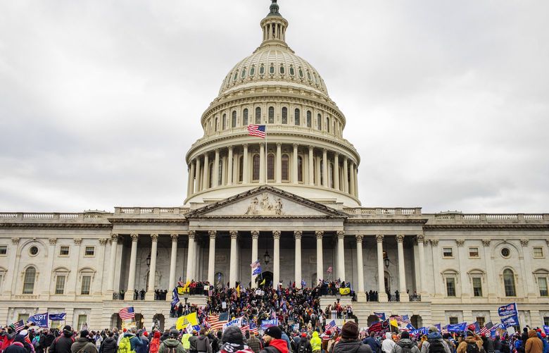 FILE — Supporters of President Donald Trump surround the Capitol in Washington, Jan. 6, 2021. About 200 people have pleaded guilty so far to charges connected to the attack that day. (Jason Andrew/The New York Times) XNYT124 XNYT124