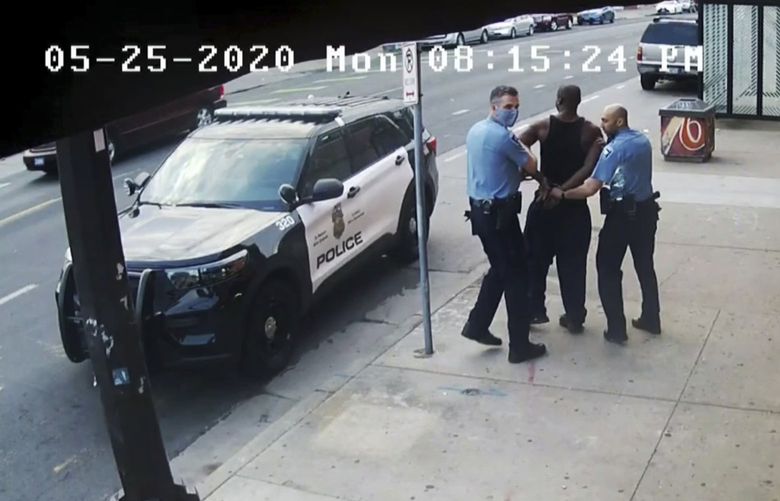 FILE – This image from surveillance video introduced into evidence during court shows Minneapolis police Officers Thomas Lane, left and J. Alexander Kueng, right, escorting George Floyd, center, to a police vehicle outside Cup Foods in Minneapolis, on May 25, 2020. Former police officers Tou Thao, Kueng and Lane are on trial in federal court accused of violating Floyd’s civil rights as fellow Officer Derek Chauvin killed him. (Surveillance Video/State of Minnesota via AP, File) CER502 CER502