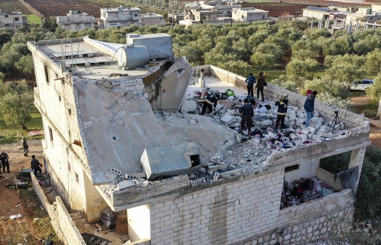 People inspect a destroyed house following an operation by the U.S. military in the Syrian village of Atmeh, in Idlib province, Syria, Thursday, Feb. 3, 2022. U.S. special operations forces conducted a large-scale counterterrorism raid in northwestern Syria overnight Thursday, in what the Pentagon said was a “successful mission.” Residents and activists reported multiple deaths including civilians from the attack. (AP Photo/Ghaith Alsayed) HAS110 HAS110
