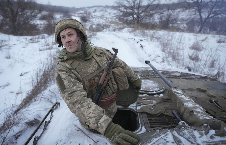 FILE A Ukrainian serviceman looks back from atop an armored personnel carrier driving near a front line position in the Luhansk area, eastern Ukraine, Friday, Jan. 28, 2022. As a political novice running to be Ukraineâ€™s president, Volodymyr Zelenskyy vowed to reach out to Russia-backed rebels in the east who were fighting Ukrainian forces and make strides toward resolving the conflict. The assurances contributed to his landslide victory in 2019. (AP Photo/Vadim Ghirda, File) XAZ913 XAZ913