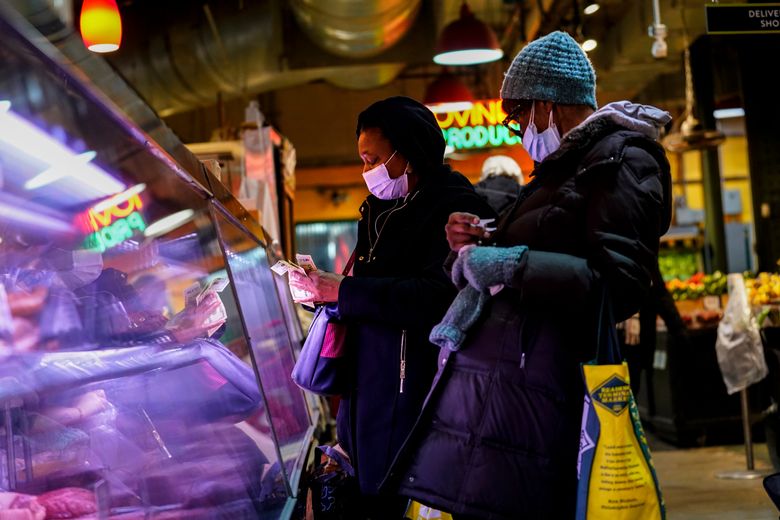 2022 年 2 月 16 日,星期三,在费城雷丁终端市场,顾客戴着口罩以防止冠状病毒商店的传播。费城市政府官员取消了该市对室内餐厅和其他提供食品和饮料的场所的疫苗授权,但室内口罩要求仍然有效。 费城公共卫生官员周三宣布立即取消疫苗授权。 (美联社照片/马特洛克)