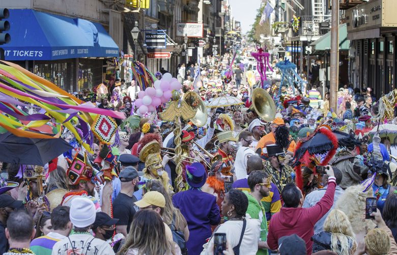 The streets are packed with costumed revelers on Mardi Gras Day in New Orleans, Tuesday, March 1, 2022. (David Grunfeld/The Times-Picayune/The New Orleans Advocate via AP) LAORS419 LAORS419 (David Grunfeld / The Associated Press)