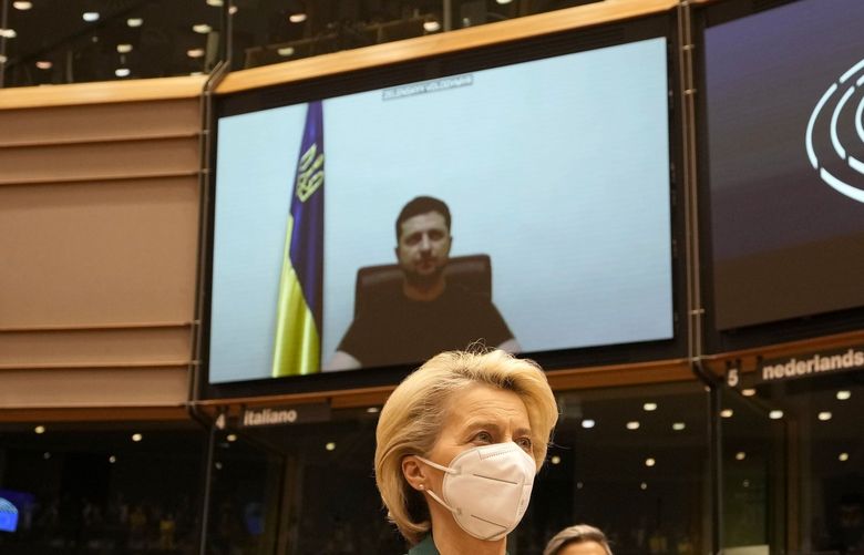 European Commission President Ursula von der Leyen applauds after an address by Ukraine’s President Volodymyr Zelenskyy, via video link, during an extraordinary session on Ukraine at the European Parliament in Brussels, Tuesday, March 1, 2022. The European Union’s legislature meets in an extraordinary session to assess the war in Ukraine and condemn the invasion of Russia. EU Commission President Ursula von der Leyen and Council President Charles Michel will be among the speakers. (AP Photo/Virginia Mayo) VLM124 VLM124