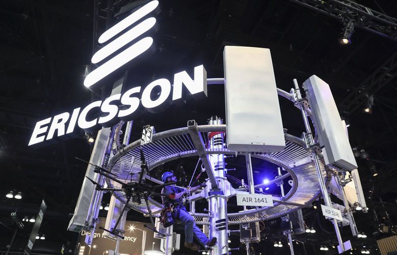 A tower climber hangs from a display of 5G wireless radio antennas at the Telefonaktiebolaget LM Ericsson booth during the Mobile World Congress Americas event in Los Angeles, California, U.S., on Wednesday, Oct. 23, 2019. The conference features prominent executives representing mobile operators, device manufacturers, technology providers, vendors and content owners from across the world. Photographer: Patrick T. Fallon/Bloomberg