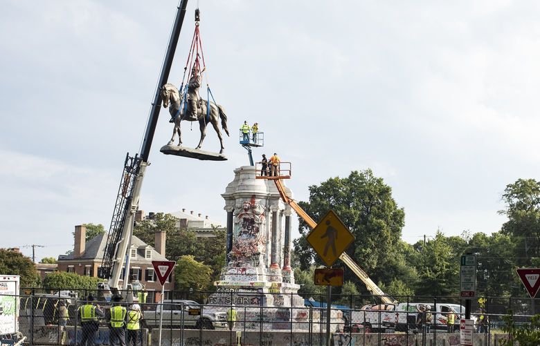 FILE – The statue of Confederate Gen. Robert E. Lee is removed from atop the monument at Marcus-David Peters Circle, Richmond, Va., Sept. 8, 2021. The murder of George Floyd nearly two years ago sparked critical conversations about systemic racism in America, and also unleashed a movement to remove, relocate and rename monuments and other symbols of the Confederacy. (Brian Palmer/The New York Times) XNYT68 XNYT68