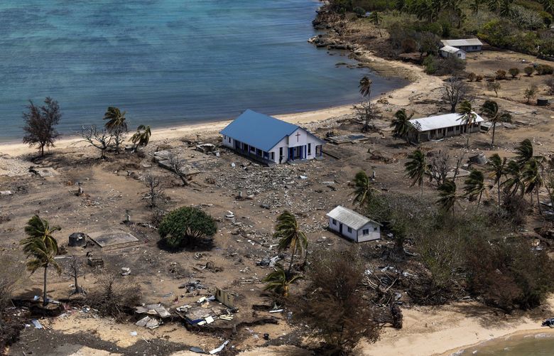 FILE – In this photo provided by the Australian Defence Force, debris from damaged building and trees are strewn around on Atata Island in Tonga, on Jan. 28, 2022, following the eruption of an underwater volcano and subsequent tsunami. The small Mango Island in Tonga was one of the closest to the Jan. 15 volcanic eruption that was so huge it echoed around the world. Every single home on the island was destroyed by the tsunami that followed. (POIS Christopher Szumlanski/Australian Defence Force via AP, File) SYD103 SYD103