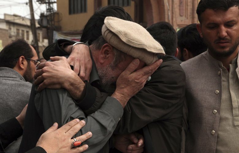 Men cry during the funeral prayers for the victims of Friday’s suicide bombing in Peshawar, Pakistan, Saturday, March 5, 2022. The Islamic State says a lone Afghan suicide bomber struck inside a Shiite Muslim mosque in Pakistan’s northwestern city of Peshawar during Friday prayers, killing dozens worshippers and wounding more than 190 people. (AP Photo/Muhammas Sajjad) XRG108 XRG108