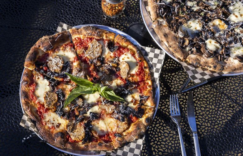 The Pat Kane, left, and Amy Marie pizzas from Local 104, a restaurant in Lake Forest Park, on Thursday, May 3, 2022. The Pat Kane includes tomato sauce, charred onion, meatball, fior di latte, basil and parmesan. The Amy Marie includes mushroom, sottocenere al tartufo, fior di latte, thyme and truffle salt.