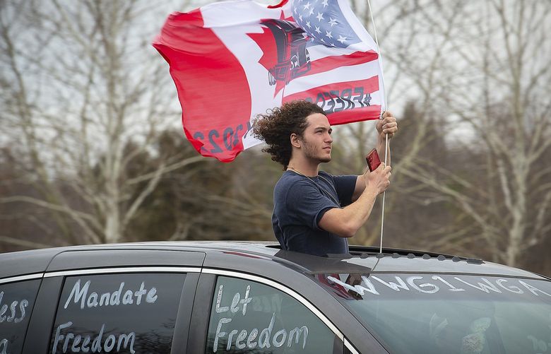 Supporters drive near the New Design Road bridge over I-270 in Frederick County as the â€œPeopleâ€™s Convoyâ€ passed through the county as they make their way from Hagerstown to Washington, Sunday, March 6, 2022. (Bill Green/The Frederick News-Post via AP) MDFRE211 MDFRE211
