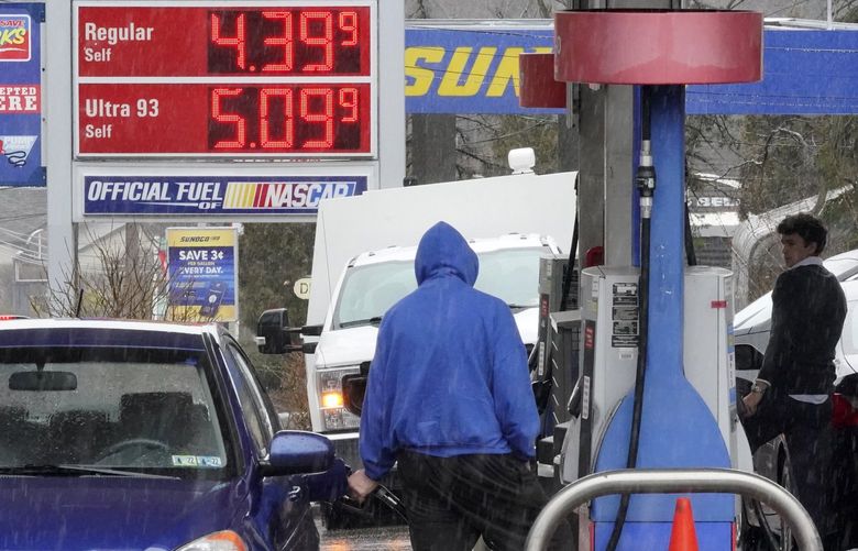 People pump gas at a Giant Eagle GetGo where a gallon of unleaded regular gas is $4.19.9, while at a neighboring Sunoco station, rear, a gallon of unleaded regular is $4.39.9, in Mount Lebanon, Pa., Monday, March 7, 2022. (AP Photo/Gene J. Puskar) PAGP101 PAGP101