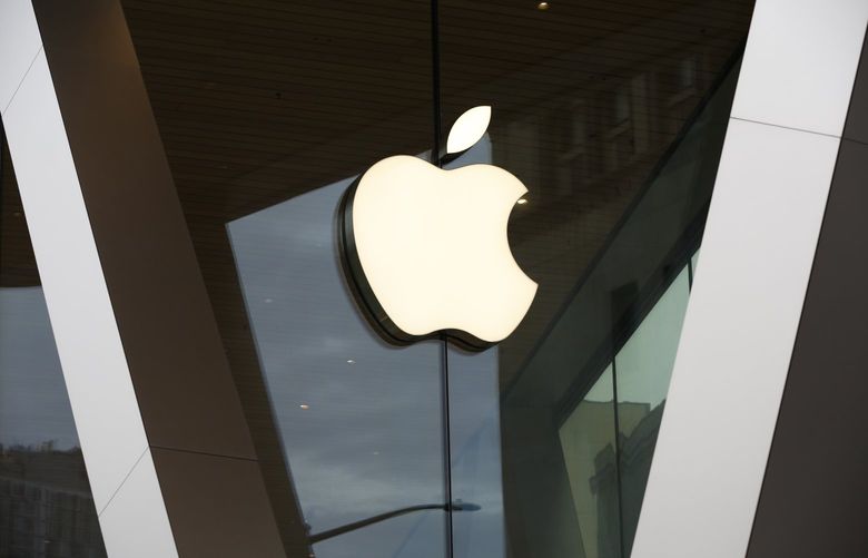FILE – In this Saturday, March 14, 2020, file photo, an Apple logo adorns the facade of the downtown Brooklyn Apple store in New York.  (AP Photo/Kathy Willens, File) NYPH701