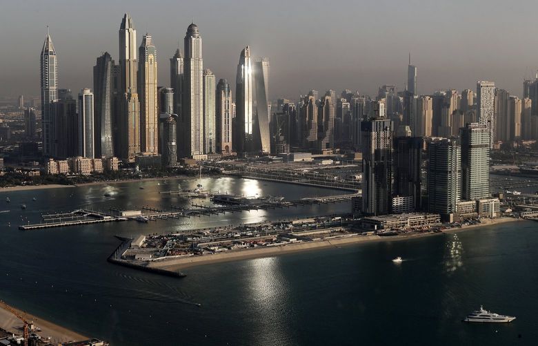 FILE – Luxury towers that dominate the skyline in the Dubai Marina district, center, and the new Dubai Harbor development, right, are seen from the observation deck of “The View at The Palm Jumeirah” in Dubai, United Arab Emirates, Tuesday, April 6, 2021. A global body focused on fighting money laundering on Friday, March 4, 2022, placed the United Arab Emirates on its so-called “gray list” over concerns that the global trade hub isn’t doing enough to stop criminals and militants from hiding wealth there. Real estate is one sector analysts say is ripe for hiding those funds. (AP Photo/Kamran Jebreili, File) ARE101 ARE101
