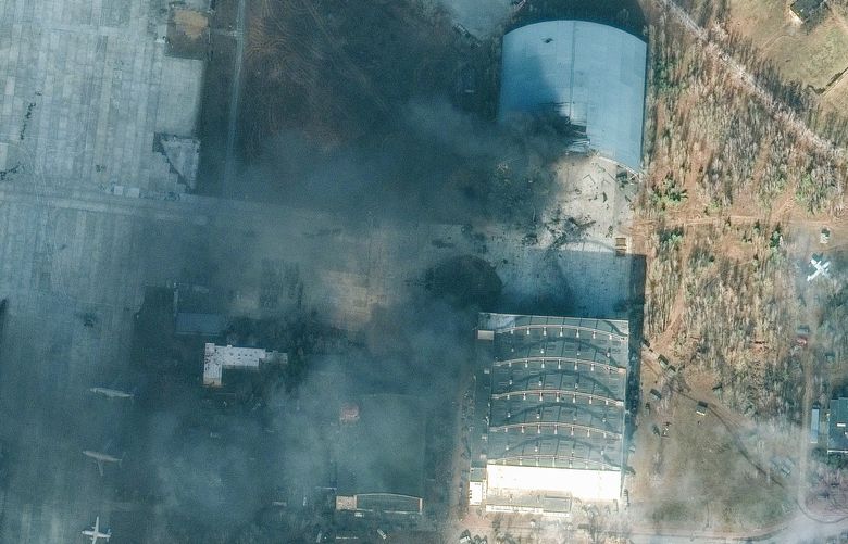 This satellite image provided by Maxar Technologies shows a damaged aircraft hangar caused by recent airstrikes and heavy fighting in and near the Antonov Airport, in Hostomel, Ukraine, Sunday, Feb. 27, 2022. (Satellite image Â©2022 Maxar Technologies via AP) NY905