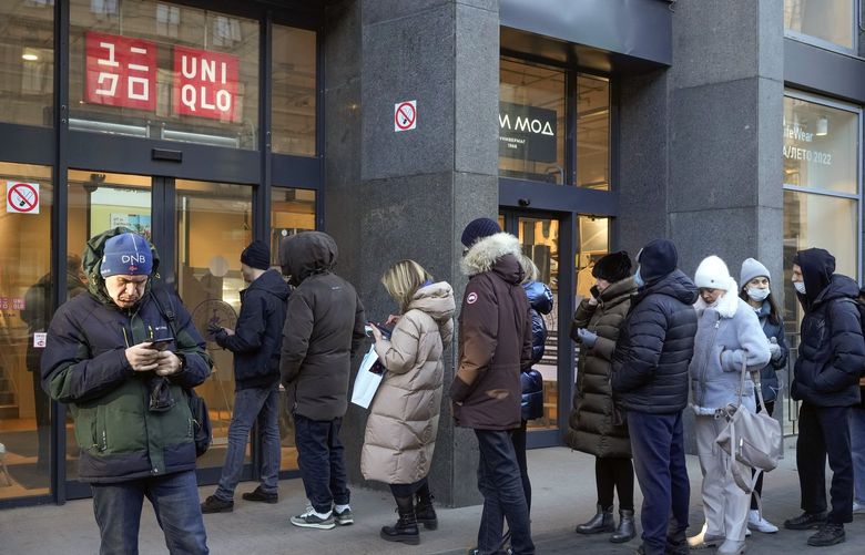 People line up at a Uniqlo store after the announcement that Uniqlo stores are suspending trade in Russia from March 21, in St. Petersburg, Russia, Thursday, March 10, 2022. (AP Photo) ARUS107 ARUS107
