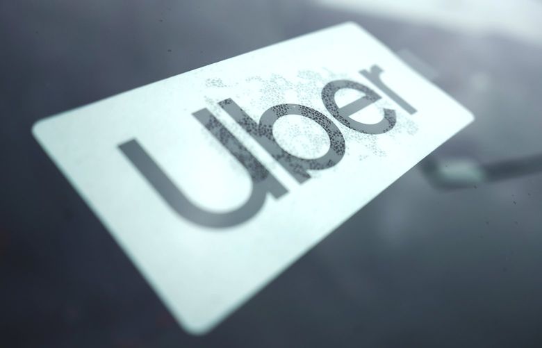 FILE – An Uber sign is displayed inside a car in Palatine, Ill., Thursday, Feb. 10, 2022. (AP Photo/Nam Y. Huh, File) 