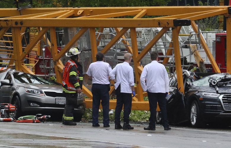 Emergency crews investigate the scene of a collapsed crane at Fairview Avenue North and Mercer Street in Seattle’s South Lake Union neighborhood Saturday afternoon.