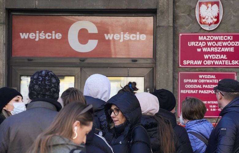Applicants wait in line at the main passport office in Warsaw, Poland, on Monday, March 14, 2022. Russia’s invasion of Poland’s neighbor Ukraine has spurred the Poles to take extra measures for their security. On Sunday, a Russian missile strike in western Ukraine, some 15 miles from Poland, killed at least 35 people. (AP Photo/Czarek Sokolowski) FS119 FS119