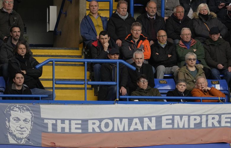 A banner in the colors of Russia’s national flag depicting Chelsea soccer club owner Roman Abramovich and reading “the Roman Empire” is shown during the English Premier League soccer match between Chelsea and Newcastle United at Stamford Bridge stadium in London, Sunday, March 13, 2022. (AP Photo/Kirsty Wigglesworth) ALT127 ALT127