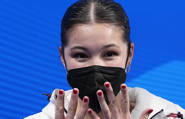FILE – Alysa Liu, of the United States, reacts after competing in the women’s free skate program during the figure skating competition at the Winter Olympics on Feb. 17, 2022, in Beijing. U.S. Olympic figure skater Alysa Liu and her father Arthur Liu â€“  a former political refugee â€“ were among those targeted in a spying operation that the Justice Department alleges was ordered by the Chinese government, the elder Liu said late Wednesday, March 16. (AP Photo/David J. Phillip, File) TKMY201 TKMY201