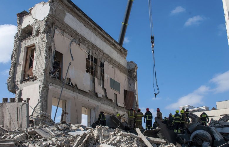 Rescuers work at the site of the National Academy of State Administration building damaged by shelling in Kharkiv, Ukraine, Friday, March 18, 2022. (AP Photo/Andrew Marienko) XB110 XB110